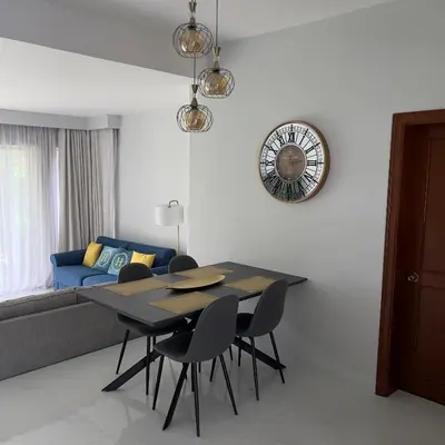 a dining room with a table and chairs and a couch at Allamanda 3 Laguna Phuket by Star in Laguna Phuket