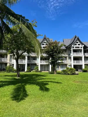 a large white building with trees in front of it at Allamanda 3 Laguna Phuket by Star in Laguna Phuket