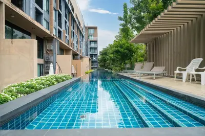 a swimming pool in the middle of a building at 1 Bedroom Apartment - The Aristo Resort by HCR in Surin Beach