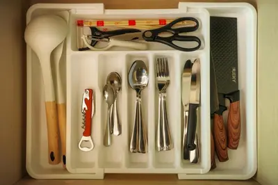 a white tray with silver utensils in it at Cozy New 1-Bedroom Apartment with Pool, 5 Min Walk to Kamala Beach in Kamala Beach