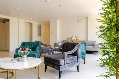 a living room with chairs and a table at Cozy New 1-Bedroom Apartment with Pool, 5 Min Walk to Kamala Beach in Kamala Beach