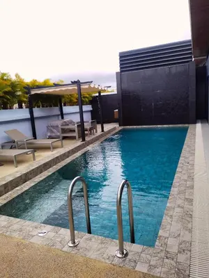 a swimming pool with rails in the middle of a building at Rawai Villa in Rawai Beach