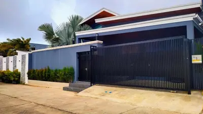 a black gate on the side of a house at Rawai Villa in Rawai Beach