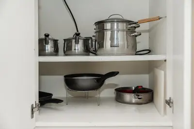 a shelf with pots and pans in a kitchen at C195 Romantic 1BR Ocean Views Cozy & Bright in Kata Beach