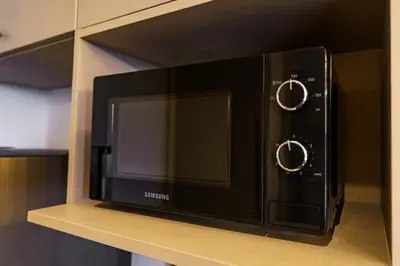 a microwave oven sitting on top of a shelf at New 1 Bdr Bellevue Lagoon Bang-Tao Beach in Laguna Phuket