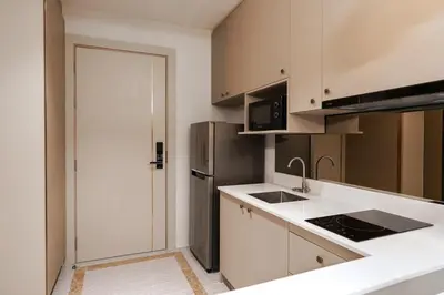 a kitchen with a sink and a refrigerator at New 1 Bdr Bellevue Lagoon Bang-Tao Beach in Laguna Phuket
