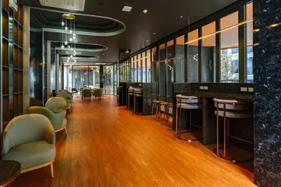 a lobby with chairs and a bar in a building at New 1 Bdr Bellevue Lagoon Bang-Tao Beach in Laguna Phuket