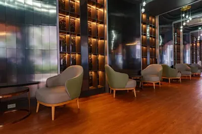 a row of chairs and tables in a room with wine bottles at New 1 Bdr Bellevue Lagoon Bang-Tao Beach in Laguna Phuket