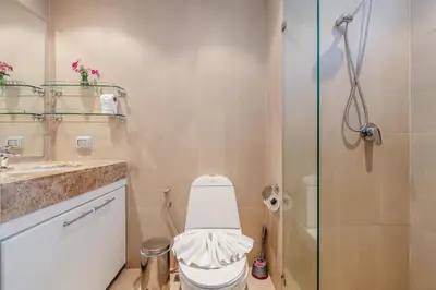 a bathroom with a toilet and a glass shower at C196 Condo 1BR Sea View & 5 Min to Beach in Kata Beach