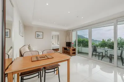 a living room with a table and a couch at C196 Condo 1BR Sea View & 5 Min to Beach in Kata Beach