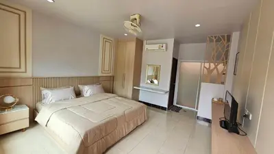 a bedroom with a bed and a television in it at วันสมายล์ รีสอร์ท in Ban Klang