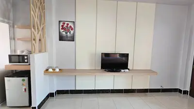 a kitchen with a counter with a television on it at วันสมายล์ รีสอร์ท in Ban Klang