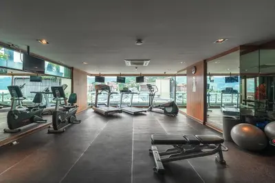 a gym with treadmills and exercise equipment in a building at C197 Condo 1BR with Pool 3 Min Walk to Beach in Patong Beach