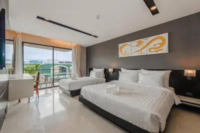 a hotel room with two beds and a balcony at C197 Condo 1BR with Pool 3 Min Walk to Beach in Patong Beach
