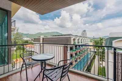 a balcony with a table and chairs and a view at C197 Condo 1BR with Pool 3 Min Walk to Beach in Patong Beach