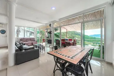 a living room with a table and a couch at V199 Villa 4BR Relaxing with Best Views in Patong in Patong Beach