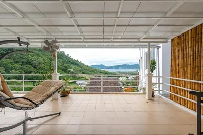 a balcony with a chair and a view of the mountains at V199 Villa 4BR Relaxing with Best Views in Patong in Patong Beach