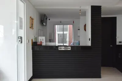a room with a black counter with a sign on it at Lae Lay Suite in Karon Beach