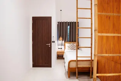a bedroom with a bunk bed and a ladder at Villa Lydia, Koh Yao Noi in Ko Yao Noi