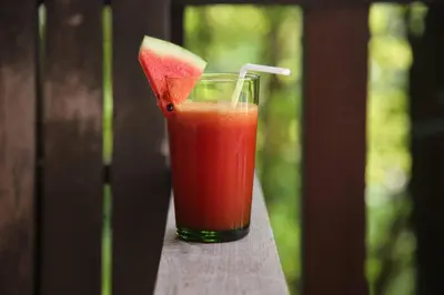 a glass of juice with a slice of watermelon at Villa Lydia, Koh Yao Noi in Ko Yao Noi