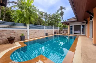 a swimming pool in the middle of a house at 3 Bedroom Pool Villa 5kms from Patong in Kathu