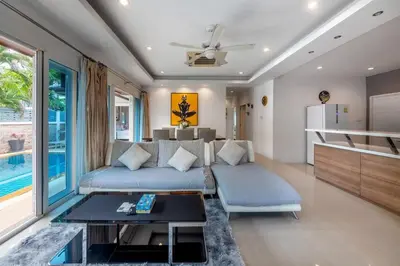a living room with a couch and a table at 3 Bedroom Pool Villa 5kms from Patong in Kathu
