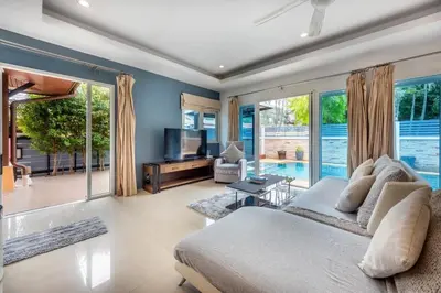 a living room with a large bed and a television at 3 Bedroom Pool Villa 5kms from Patong in Kathu