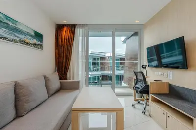 a living room with a couch and a large window at C198 Oceanview Stay Gym, Pool & Walk to Beach in Rawai Beach