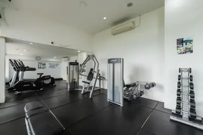 a gym with treadmills and machines in a room at C198 Oceanview Stay Gym, Pool & Walk to Beach in Rawai Beach