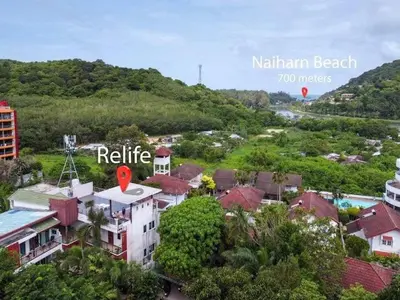 a view of a town with buildings and trees at C199 Condo 1BR Walk to Lake, Beach, Bars & Market in Rawai Beach