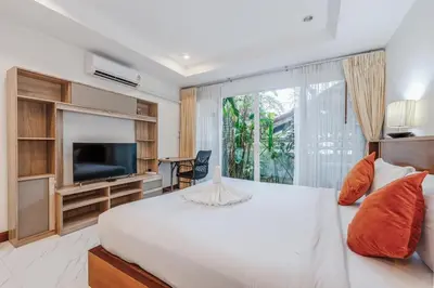 a bedroom with a white bed and a large window at C199 Condo 1BR Walk to Lake, Beach, Bars & Market in Rawai Beach