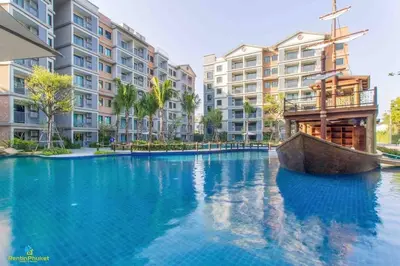 a large swimming pool with a boat in front of some buildings at B9 Ватсап669З5В2I976 in Nai Yang Beach