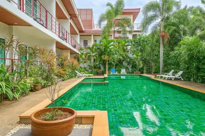 a swimming pool in the middle of a building at C200 Relaxing 1BR Stay Walk to Nai Harn Beach in Rawai Beach