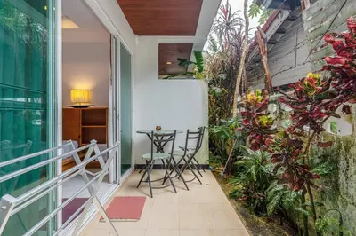 a small balcony with chairs and plants on it at C200 Relaxing 1BR Stay Walk to Nai Harn Beach in Rawai Beach