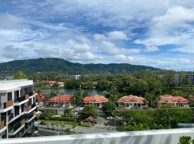 a view of a resort with a lake and buildings at Cozy studio Laguna SkyPark Phuket in Laguna Phuket
