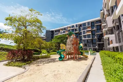a playground in front of a apartment building at Cozy studio Laguna SkyPark Phuket in Laguna Phuket