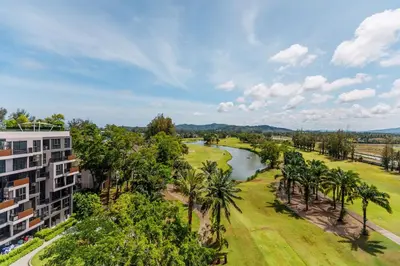an aerial view of a resort with a river and palm trees at Cozy studio Laguna SkyPark Phuket in Laguna Phuket