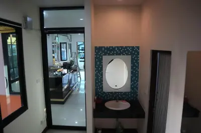a bathroom with a sink and a mirror on the wall at Cocoloco hostel in Ban Khlong Haeng