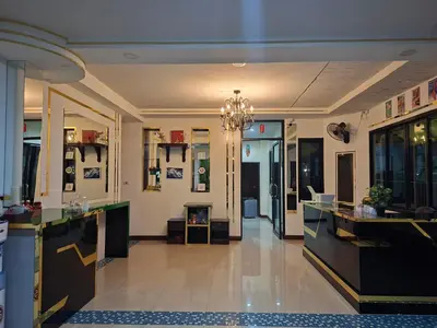 a room with a hair salon with a chandelier at Cocoloco hostel in Ban Khlong Haeng