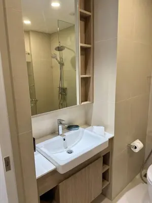 a bathroom with a sink and a mirror at Laguna SkyPark by ShowProperty in Laguna Phuket