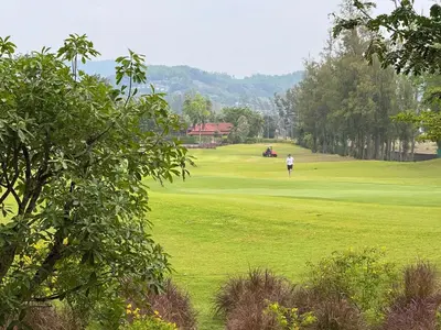 a person is playing on a golf green at Laguna SkyPark by ShowProperty in Laguna Phuket