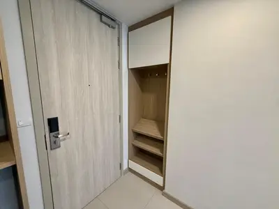 a walk in closet with a door next to it at Laguna SkyPark by ShowProperty in Laguna Phuket