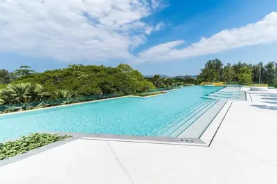 a large swimming pool with blue water at Laguna Beachside by ShowProperty in Bang Tao Beach
