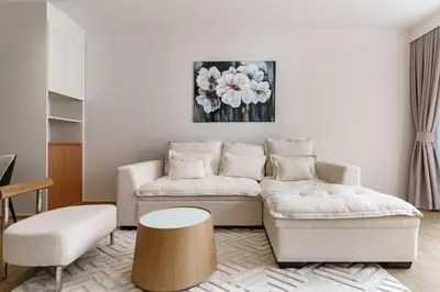 a living room with a couch and a table at Laguna Beachside by ShowProperty in Bang Tao Beach