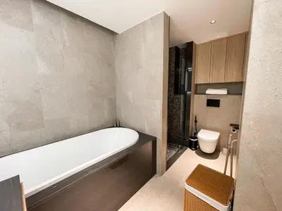 a bathroom with a bath tub and a toilet at Layan Green Residence by ShowProperty in Layan Beach