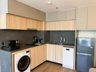 a kitchen with a washer and a dishwasher at Layan Green Residence by ShowProperty in Layan Beach