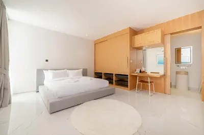 a bedroom with a bed and a desk in it at LuxPride 4BR Spacious Pool Villa for Group and Families in Ban Pak Lak