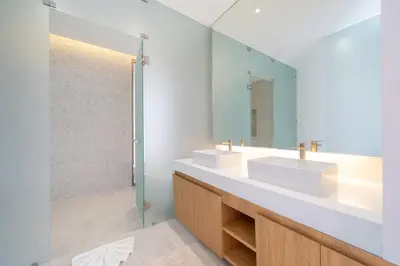 a bathroom with two sinks and a mirror at LuxPride 4BR Spacious Pool Villa for Group and Families in Ban Pak Lak