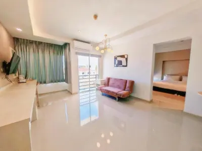 a living room with a couch and a bed at The Sleepy Place in Patong Beach