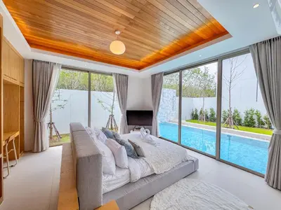a bedroom with a large bed and a swimming pool at Tropical Living in Private Pool 3BR Villa in New Residence LuxPride 4 L9 in Bang Tao Beach